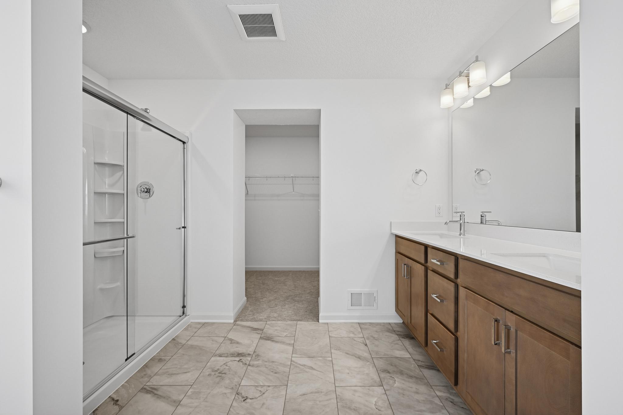 The spa-like primary bathroom complements the Owner’s Retreat with a well-appointed design that emphasizes comfort and luxury. **Photo of similar home**
