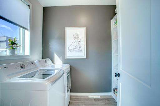 Main level laundry with custom California Closets added for ideal organization.