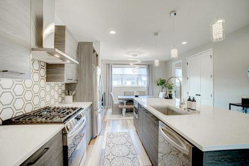 Designer light fixtures over the kitchen island and in the dining area.