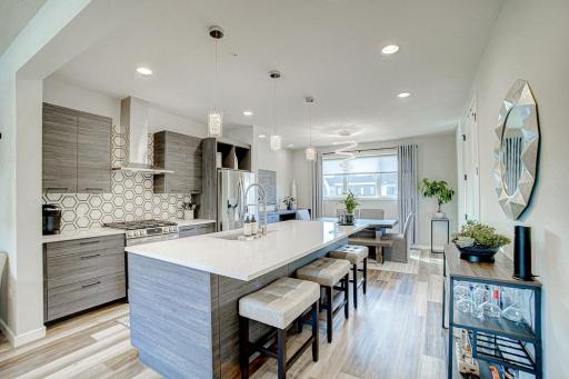 Gourmet kitchen with quartz countertops and Wi-Fi enabled LG stainless steel appliances.