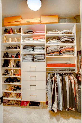 Primary walk-in closet with custom California Closets.
