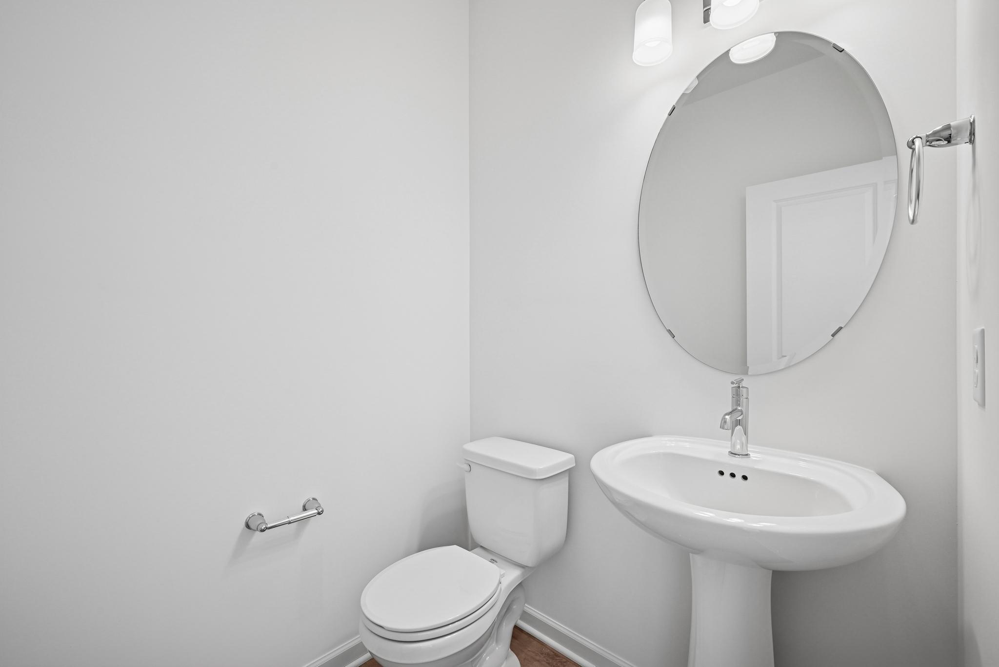 Conveniently located powder room toward the front of the home for guests. **Photo of similar home**