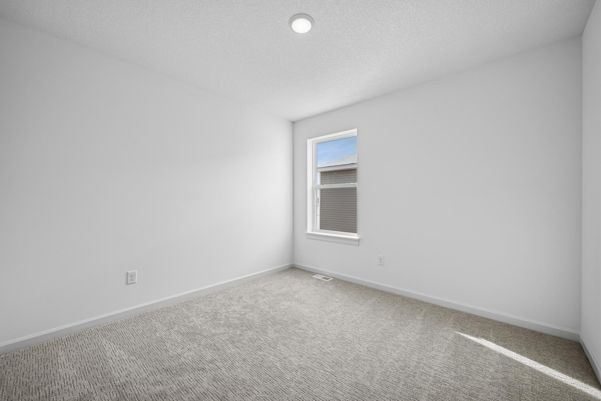 Thoughtfully designed secondary bedrooms provide flexible living options for family members or guests. **Photo of similar home**