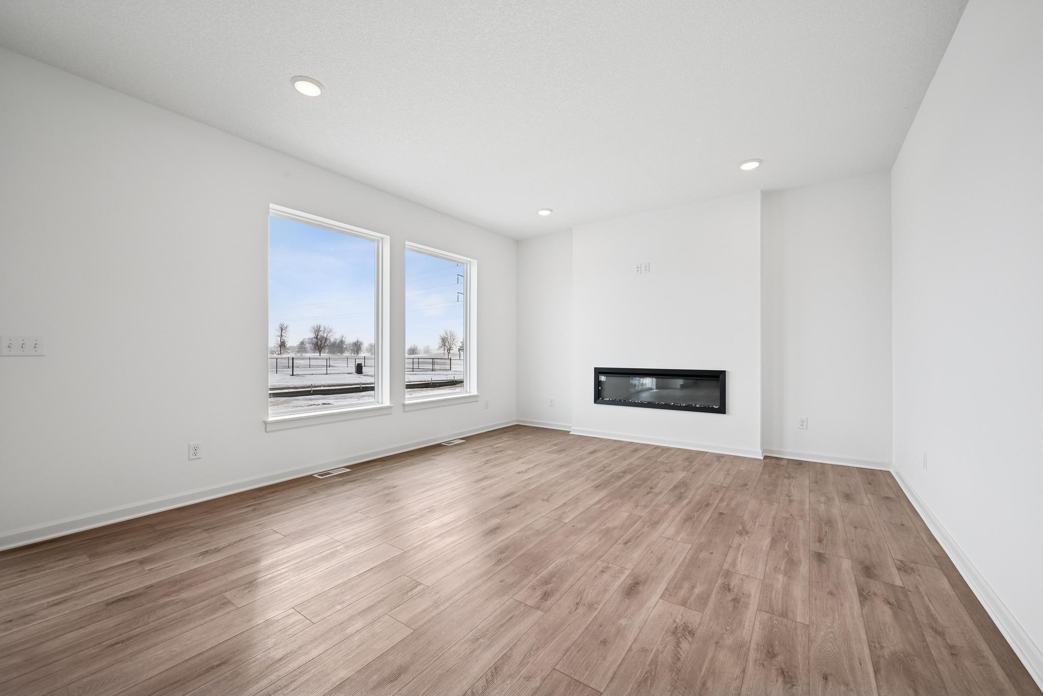 The open-concept family room is filled with natural light and enhanced by open sight lines that create a bright, inviting atmosphere. **Photo of similar home**