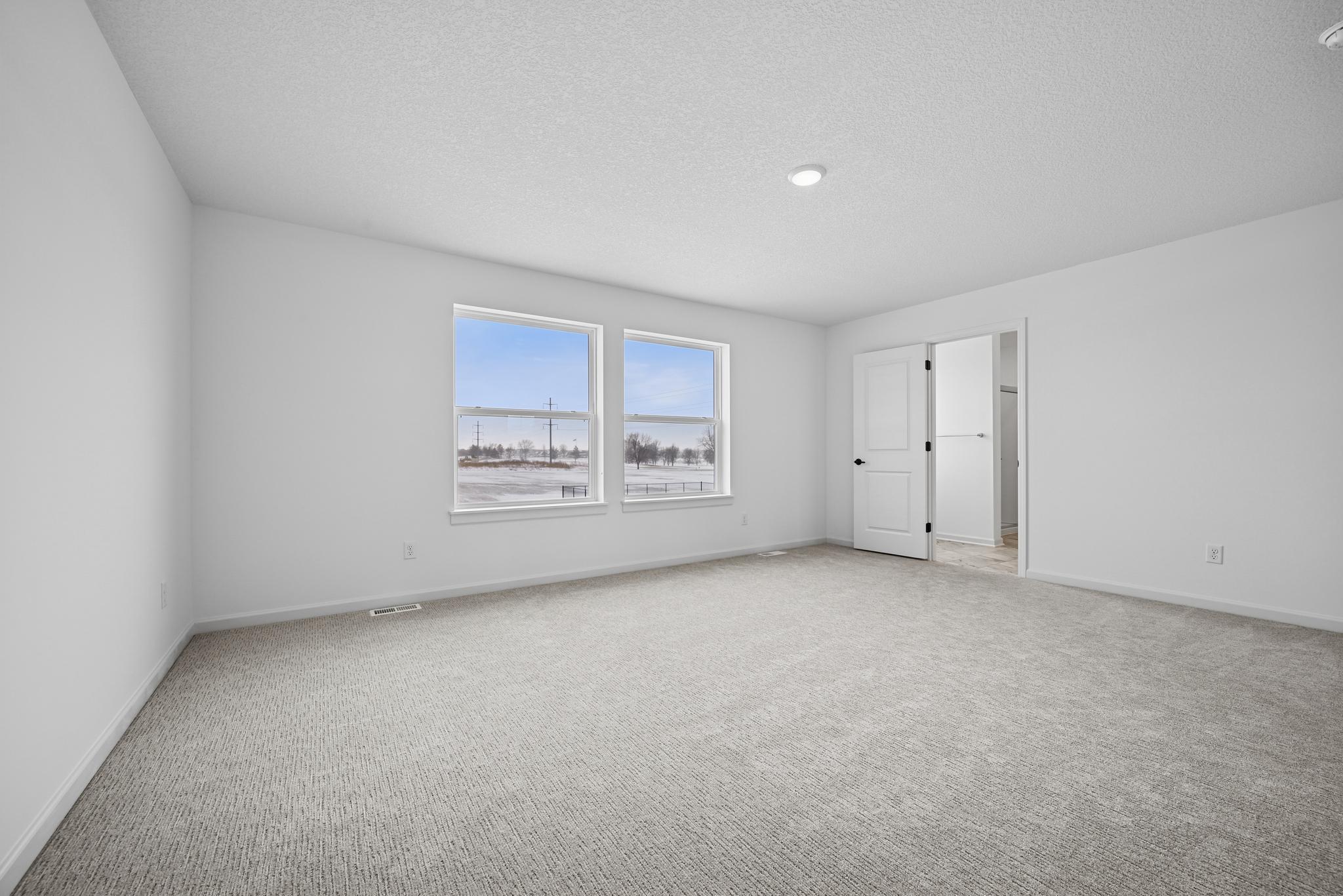 The Owner’s Retreat provides a peaceful escape from the day, offering a spacious and comfortable bedroom designed for rest and relaxation. **Photo of similar home**