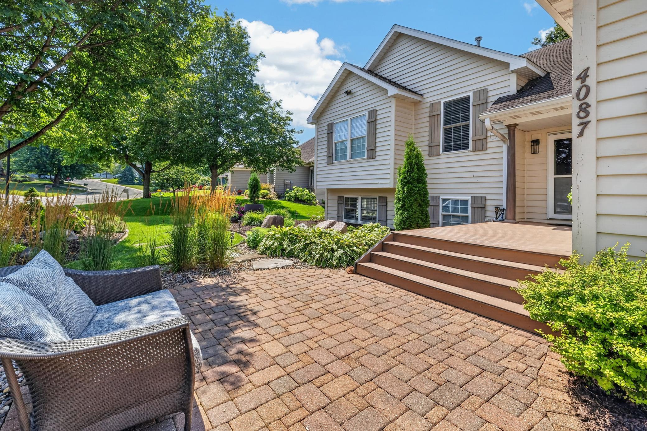 Paver patio extends the front porch, creating a welcoming sitting area!