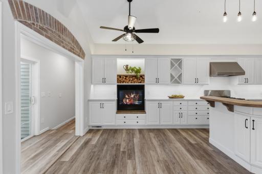 Gas fireplace carefully tucked in the cabinetry and creates a cozy hearth area! Down the hall features a separate entrance to the 3rd stall garage.