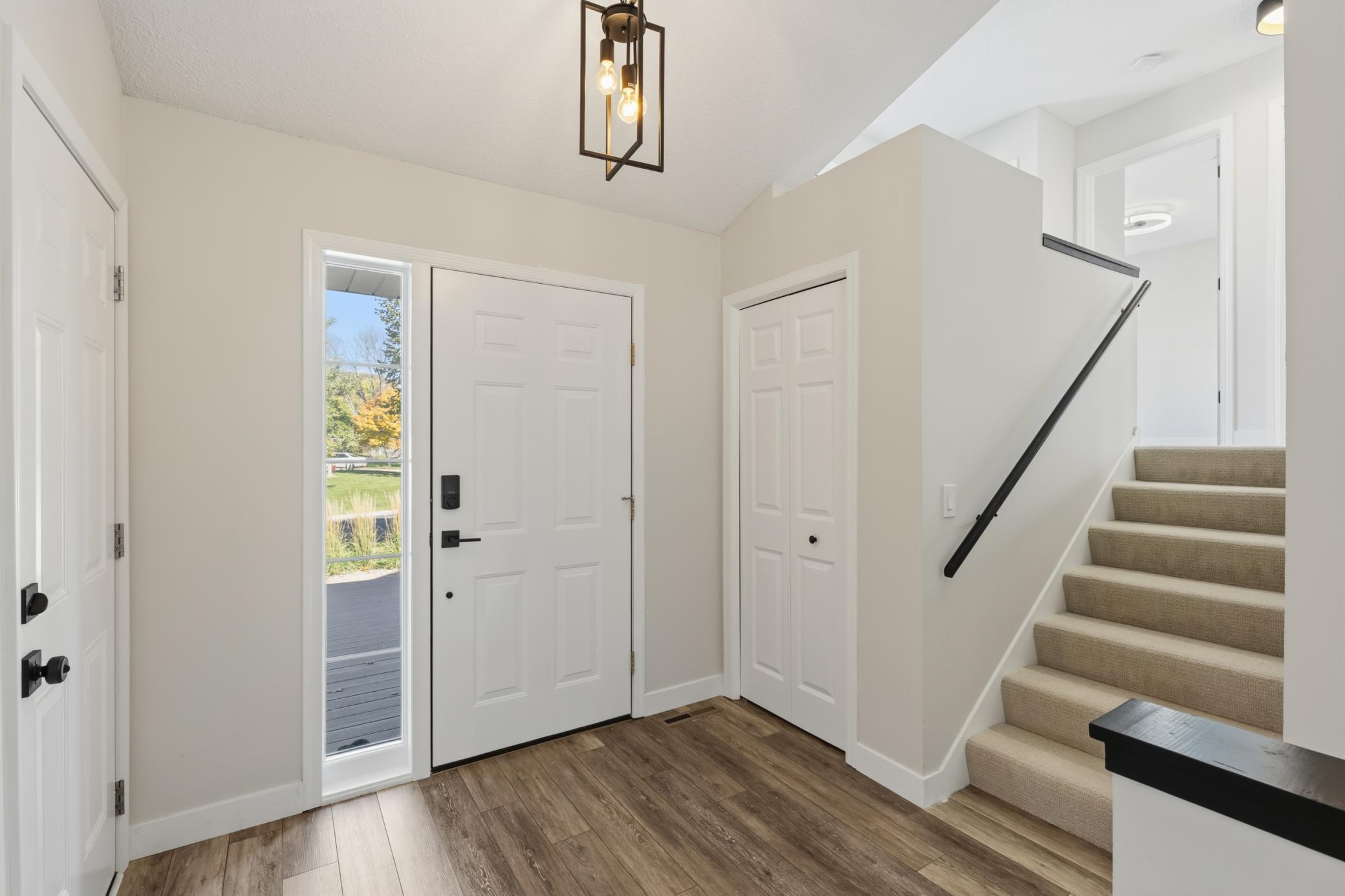 Entry features vaulted ceilings and luxury vinyl plank flooring