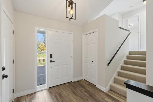 Entry features vaulted ceilings and luxury vinyl plank flooring