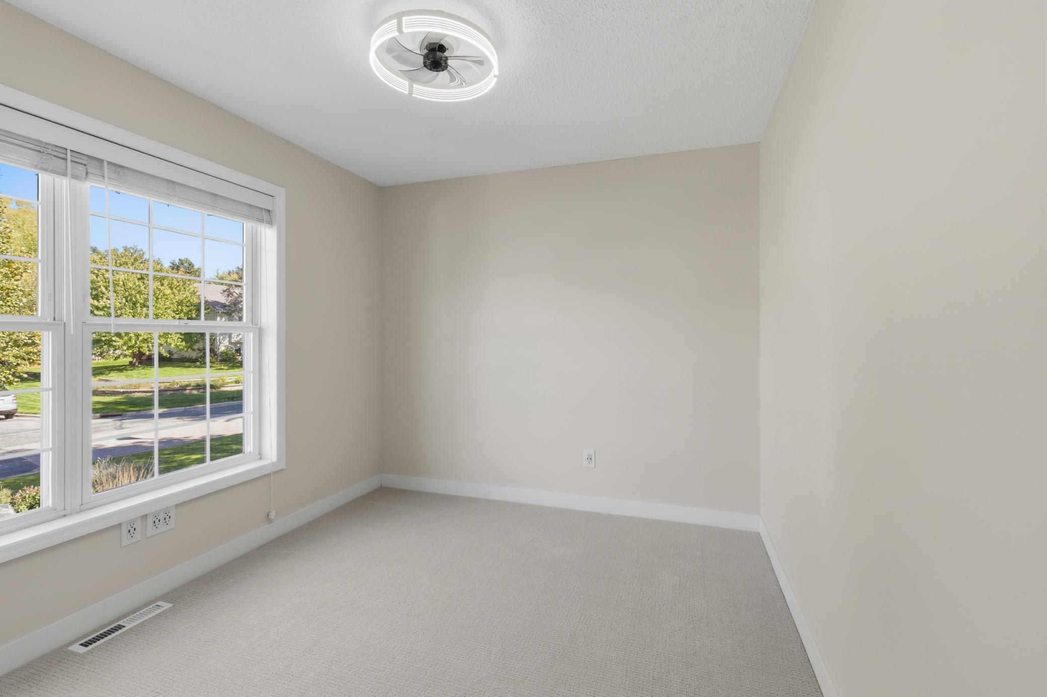 Bedroom 2 features ceiling fan and new carpet