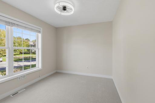 Bedroom 2 features ceiling fan and new carpet