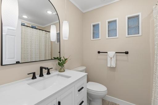 Full Bathroom on the Upper Level features enameled vanity cabinet that offers a quartz top and wide spread faucet. Luxury vinyl plank flooring