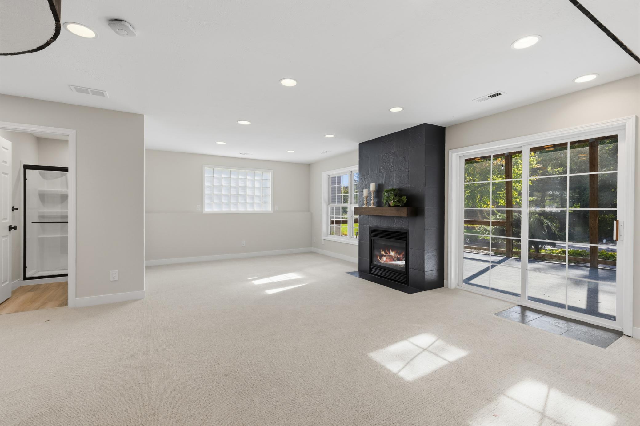 Gas fireplace with tile surround and rustic mantel
