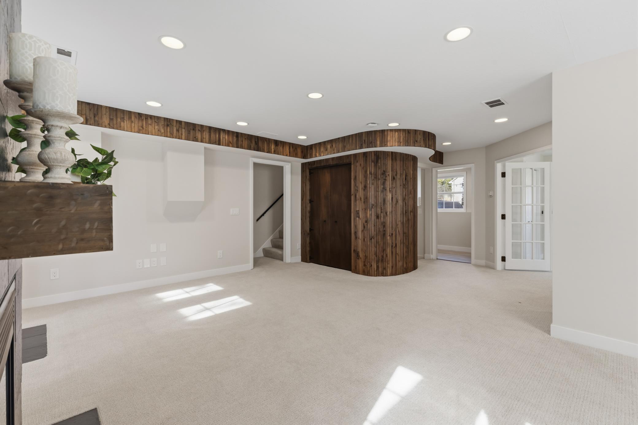Family Room features a wood paneled curved accent wall