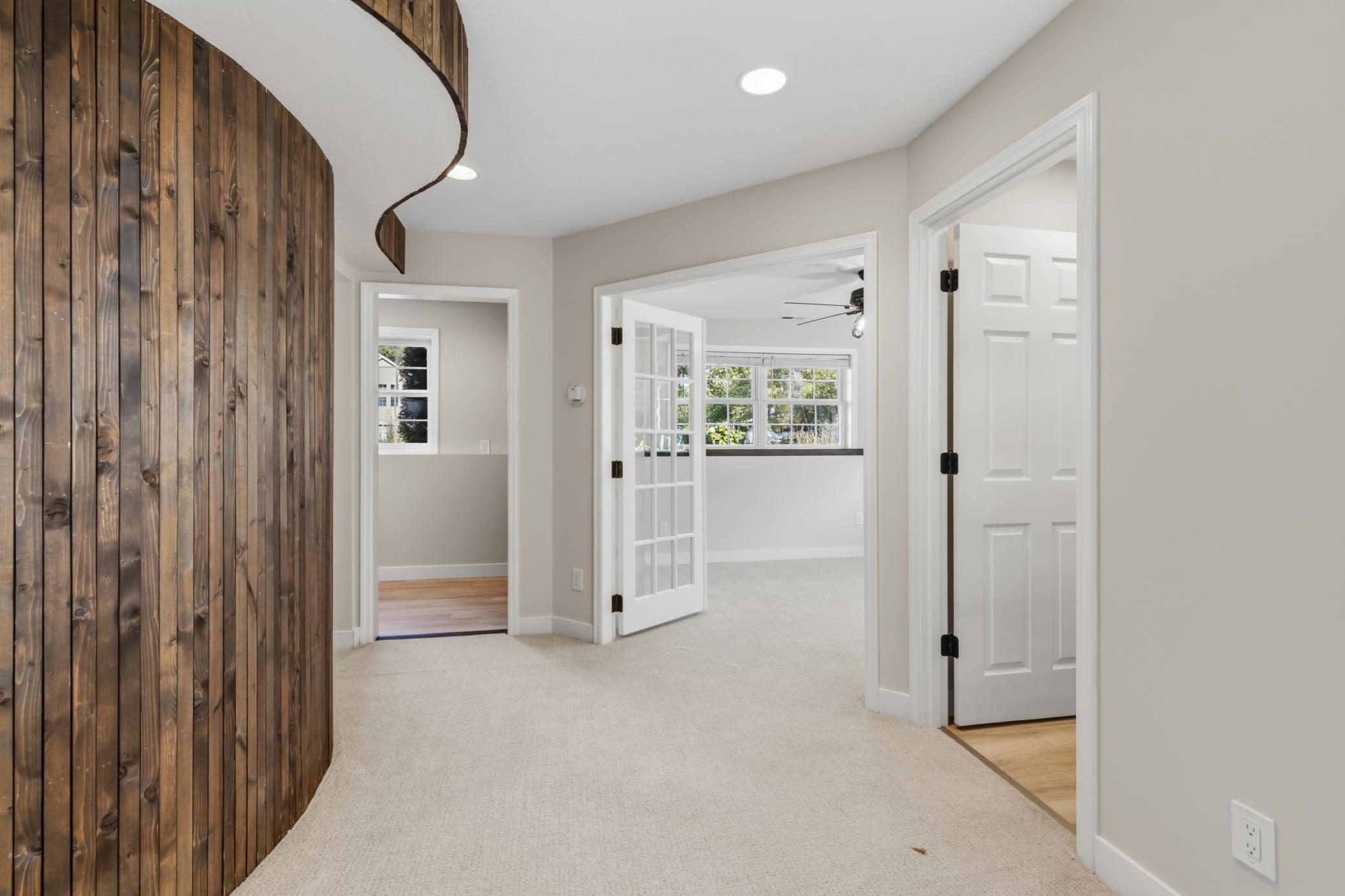 Behind the wood paneled wall features a bedroom, bathroom and laundry.