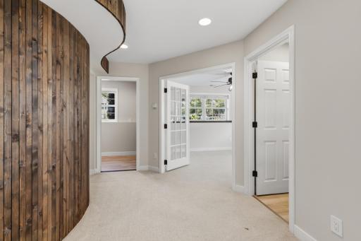 Behind the wood paneled wall features a bedroom, bathroom and laundry.