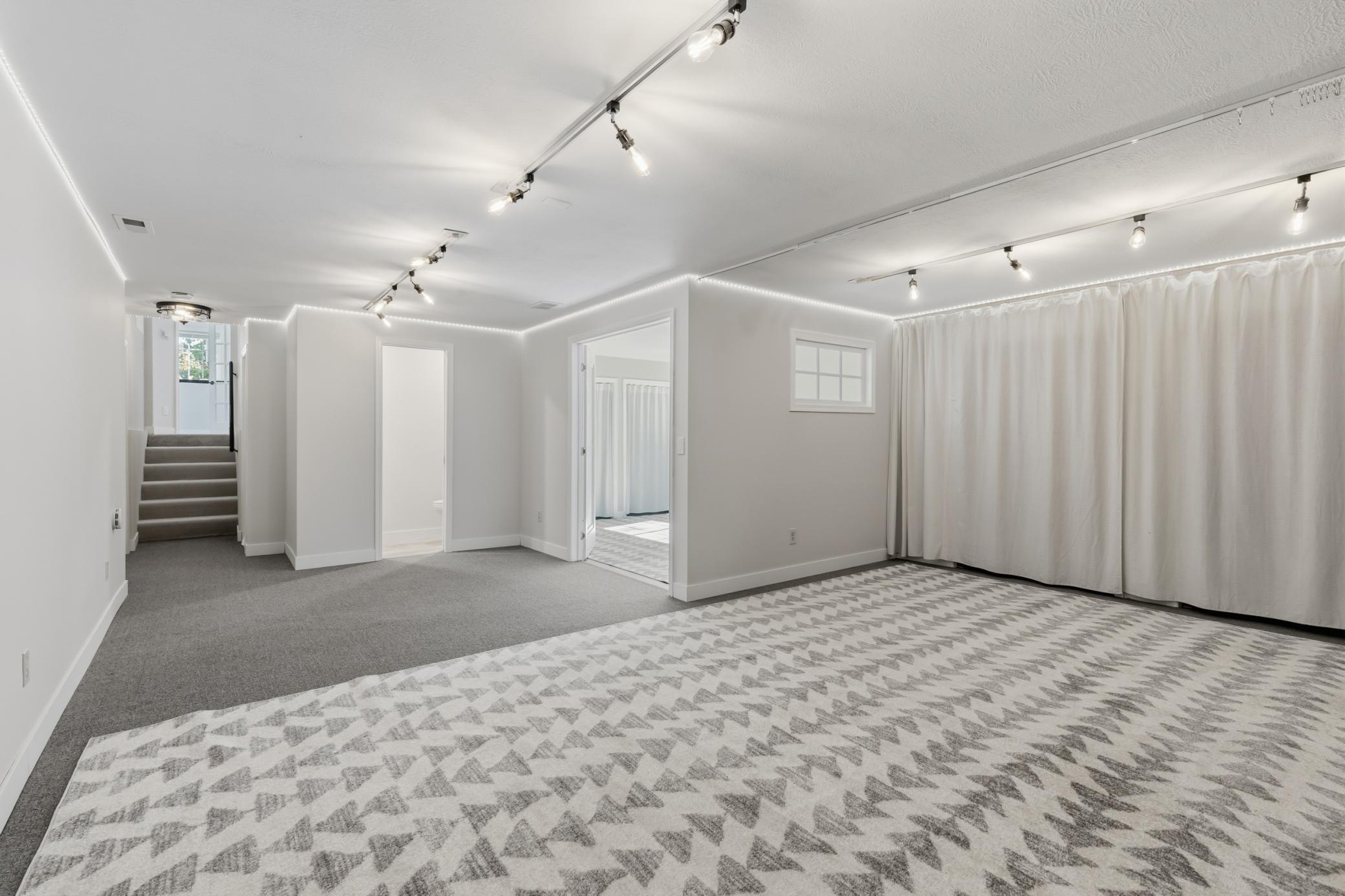 Family Room features wide open space, great for relaxing and play! Pair of storage closets as well. The 1/2 bathroom is right next to the Bedroom.
