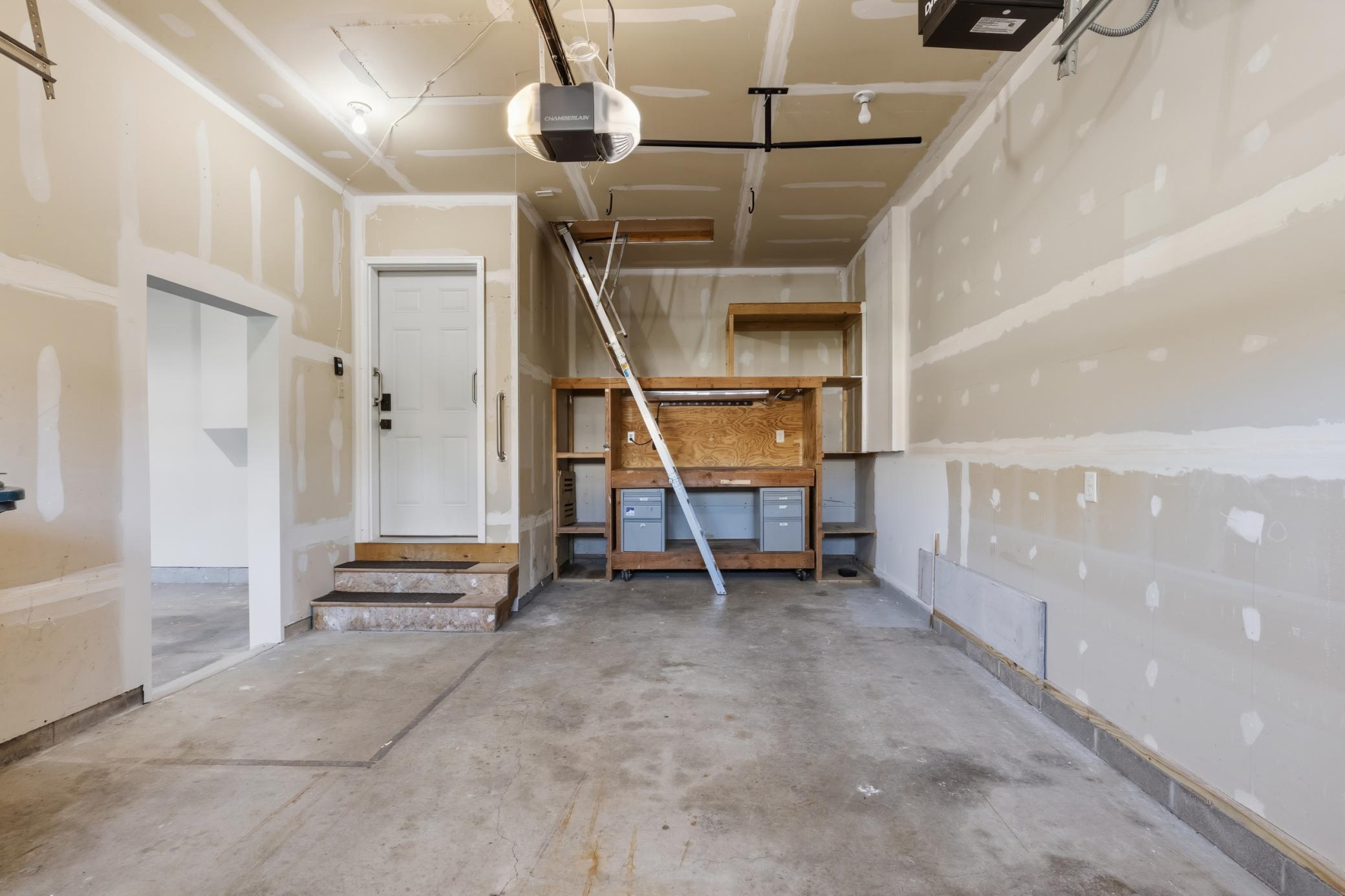 The 3rd stall offers an additional heater and built-in workbench. The ladder leads to attic space that can be used for an office, kids area, or hobby space. The garages and attic space share a separate furnace and air conditioner