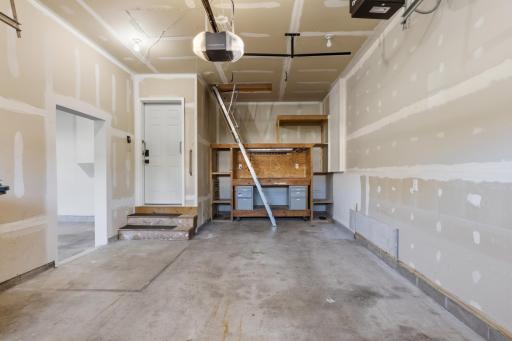 The 3rd stall offers an additional heater and built-in workbench. The ladder leads to attic space that can be used for an office, kids area, or hobby space. The garages and attic space share a separate furnace and air conditioner