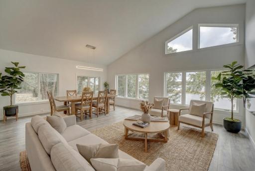 Inside, the open layout is enhanced by generous windows that flood the home with natural light and showcase breathtaking river views from nearly every room. (virtually staged)