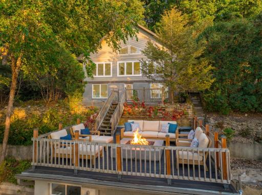 Step outside to the expansive two-tiered deck, perfect for hosting, dining al fresco, or simply soaking in the views, then head down to your private dock and boat landing with room for multiple boats and endless river adventures. (virtually staged)