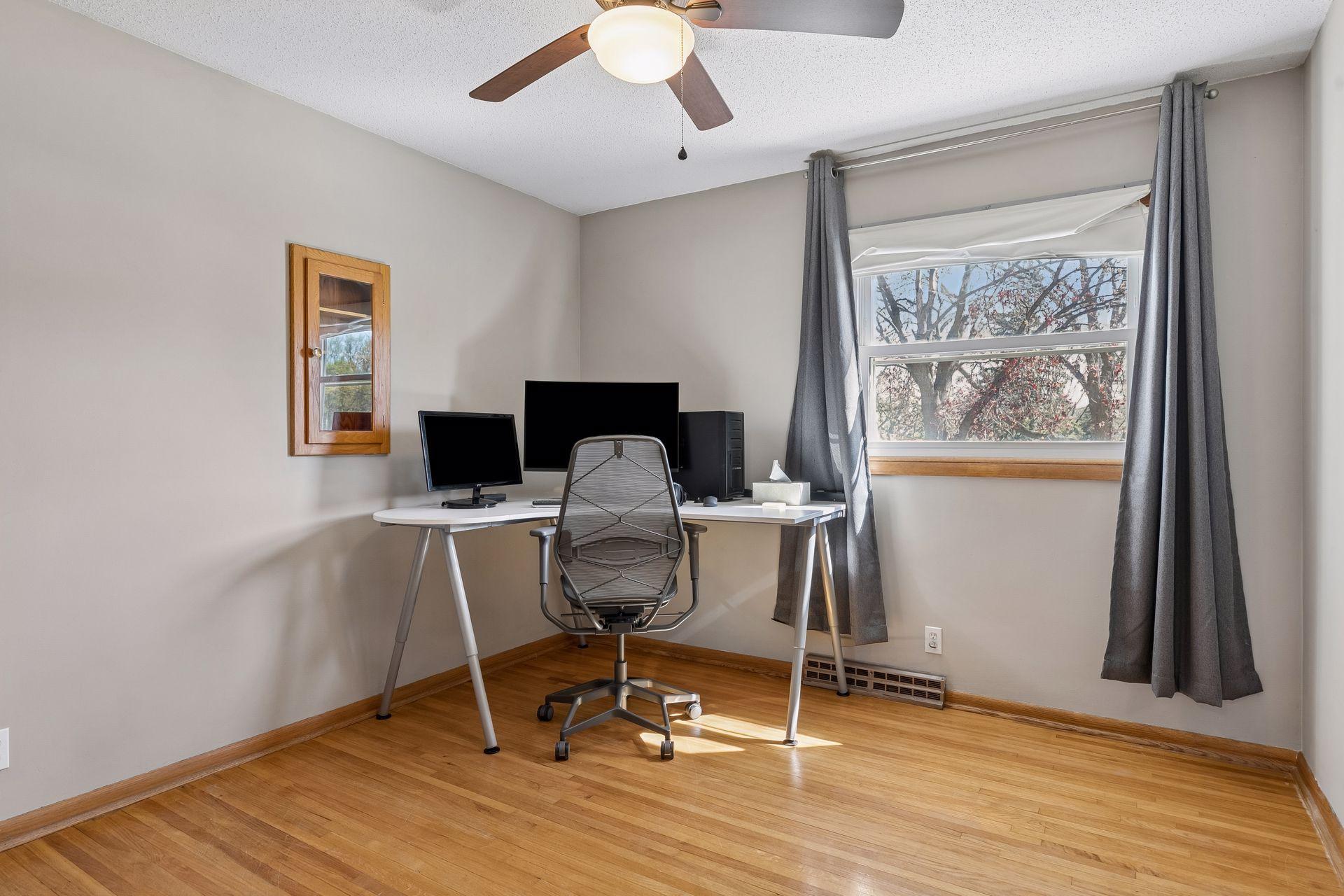 One of three bedrooms on second level with hardwood floors.
