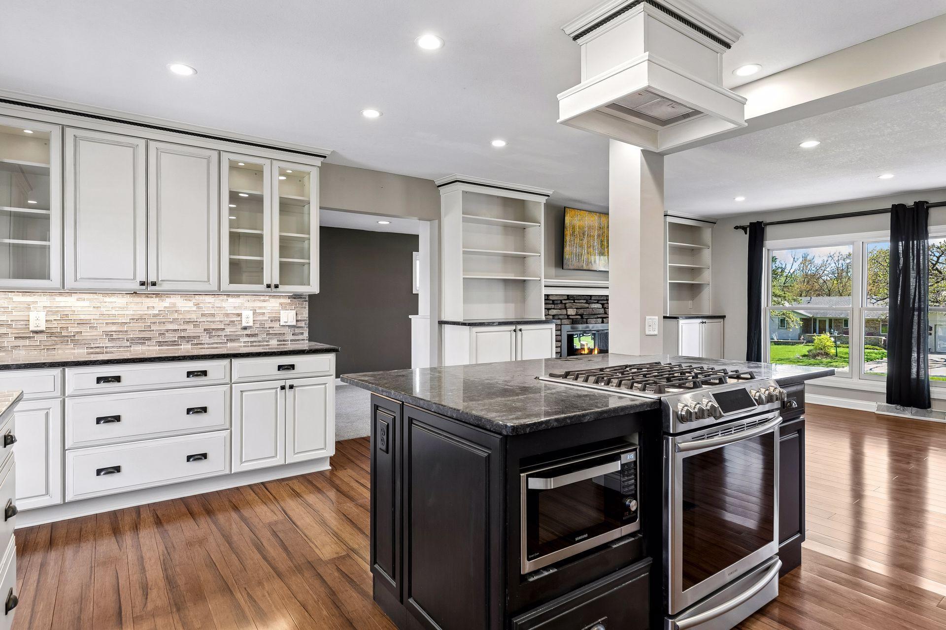 Back wall of cabinets provide pull out drawers, glass display cabinets with lighting and under cabinet lighting.