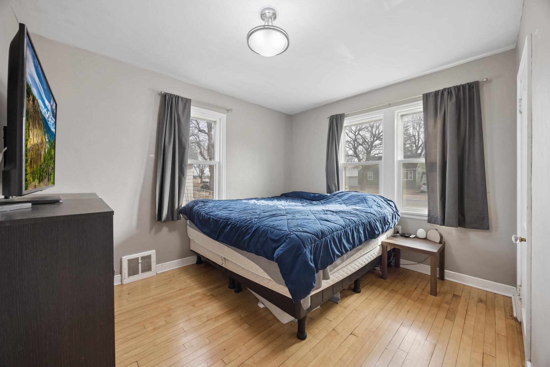 Main floor bedroom with dual windows for great natural light, hardwood floors, and a large closet!