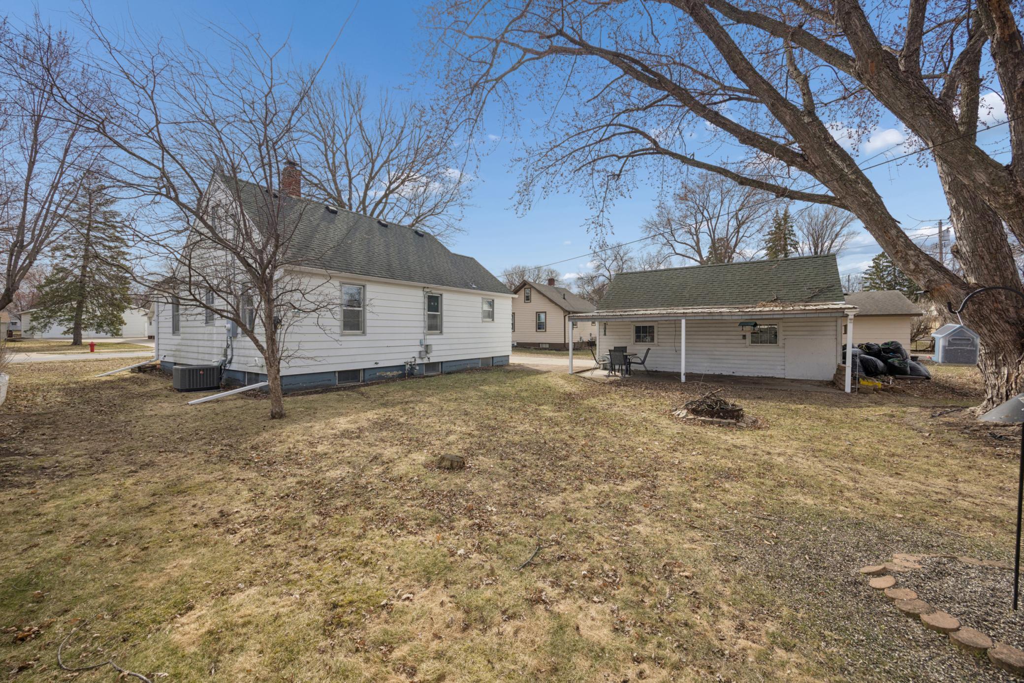Backyard is SPACIOUS! great firepit area, covered patio space, and large mature trees!