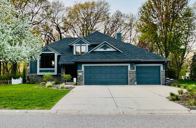 Front Photo Captured in Spring, the Home Surrounded by Fresh Blooms complete with a White Picket Fence