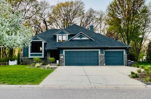 Front Photo Captured in Spring, the Home Surrounded by Fresh Blooms complete with a White Picket Fence