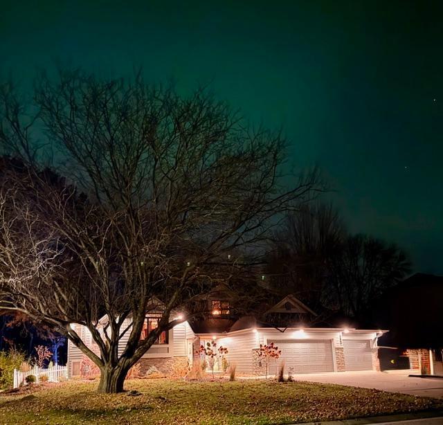 Under the Night Sky the home is framed by the Beauty of Northern Lights