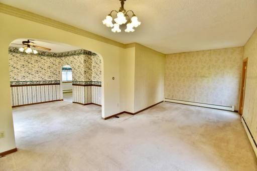 View of the open living/dining area with beautiful arched wall