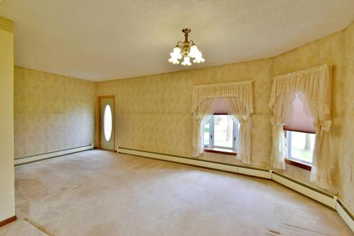 Just inside the front entrance of the house is an open living room area with lots of natural lighting