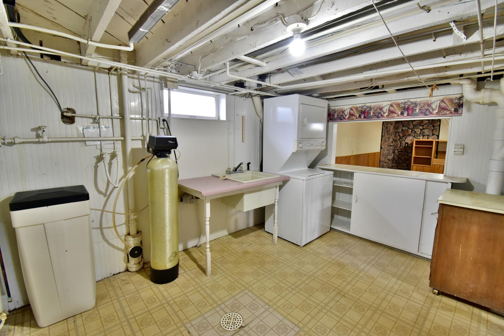 The stacked washer and dryer stay with the house! Counter to the right looks out to family room - great place for snacks!