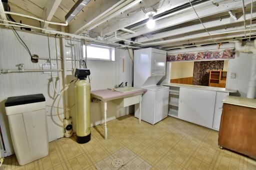 The stacked washer and dryer stay with the house! Counter to the right looks out to family room - great place for snacks!