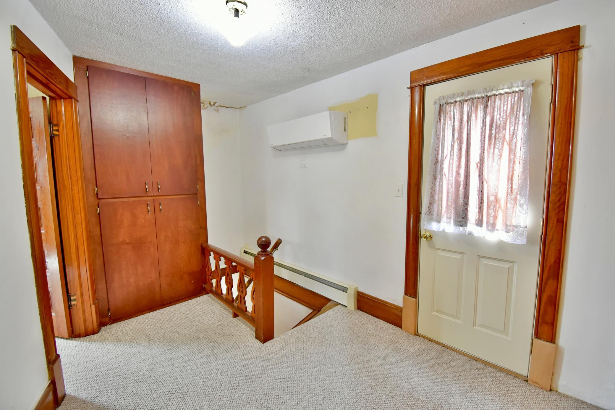 Upper level has a mini split unit, and beyond the door is the exterior unit