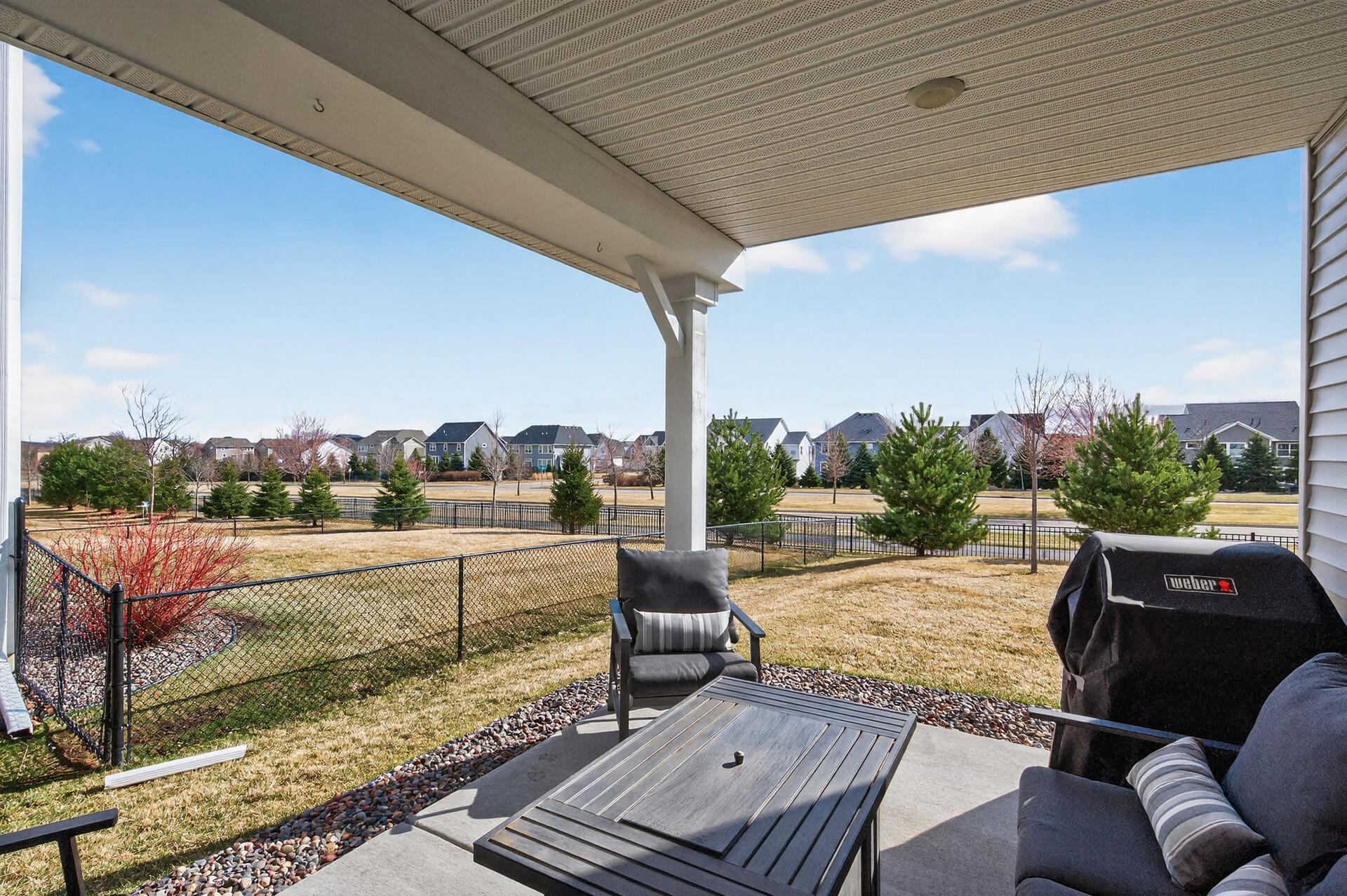 Enjoy your summer evenings on this covered patio! Perfect for grilling and entertaining! Partially fenced yard on side and back! Landscaped back yard overlooking the parkway. Hop on the sidewalk for miles of walking in Woodbury.