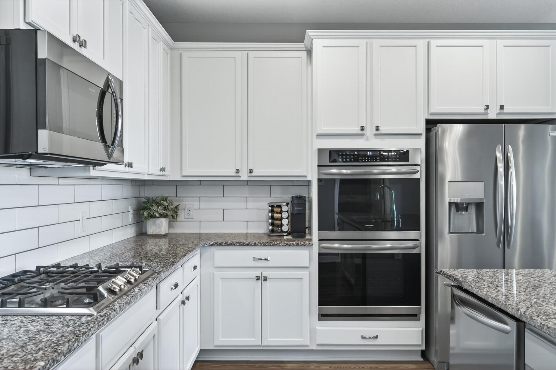 Kitchen features a double oven, perfect for home chefs and holiday entertaining.