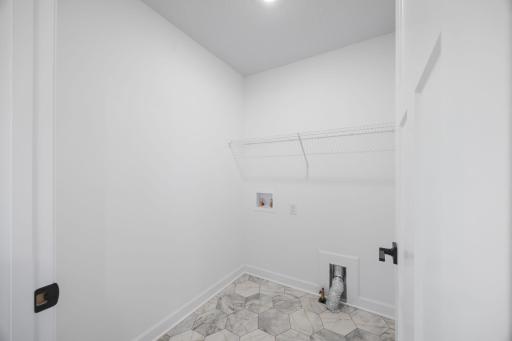 Enjoy simple chore days with a ventilated shelf and washer-dryer connections in the laundry room.