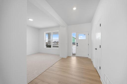 A versatile flex space situated off the foyer is ideal for a home office.