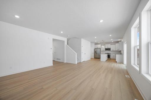 The kitchen overlooks shared rooms within the open-concept layout