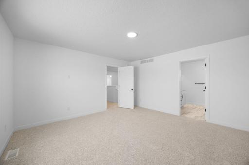 The owner’s suite is situated on the home’s second level, comprised of a restful bedroom, en-suite bathroom and walk-in closet.