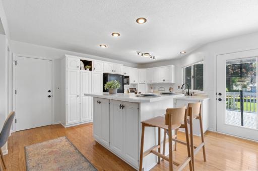 Kitchen features updated counters, island, and access to the large freshly updated deck.