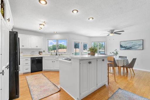 The kitchen offers generous counter space, abundant storage, and backyard views.