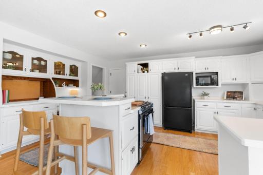 Updated kitchen with center island, breakfast bar seating, and ample cabinetry.