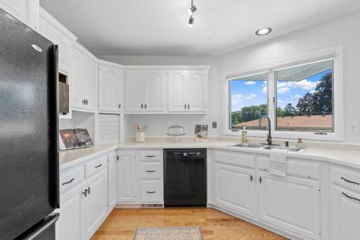 Kitchen with double sink, updated faucet, and open sightlines to dining area and living space.