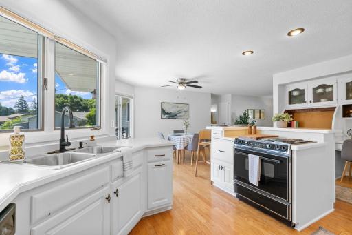 Bright, functional kitchen with large windows overlooking the backyard.