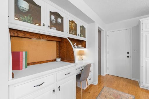 Convenient built-in desk with upper cabinets â great for a home workspace.