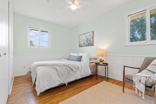 Secondary bedrooms feature hardwood floors, updated ceiling fans, and neutral paint.